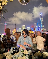 a man is djing in front of a crowd of people